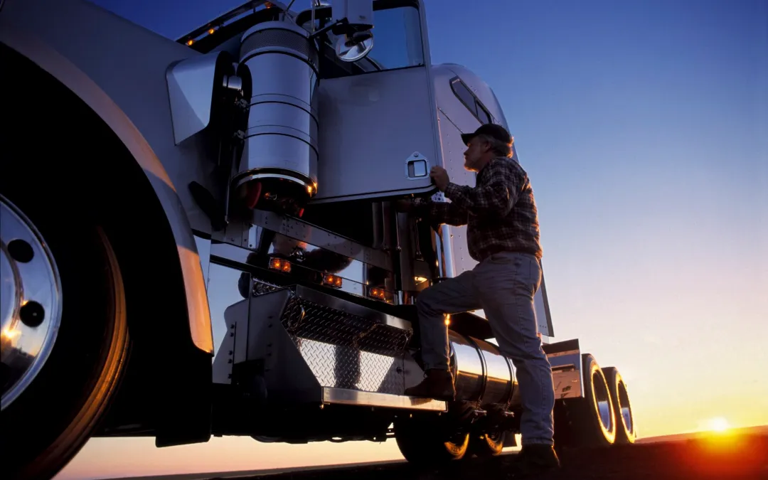 Truck driver getting into cab – commercial driver staffing